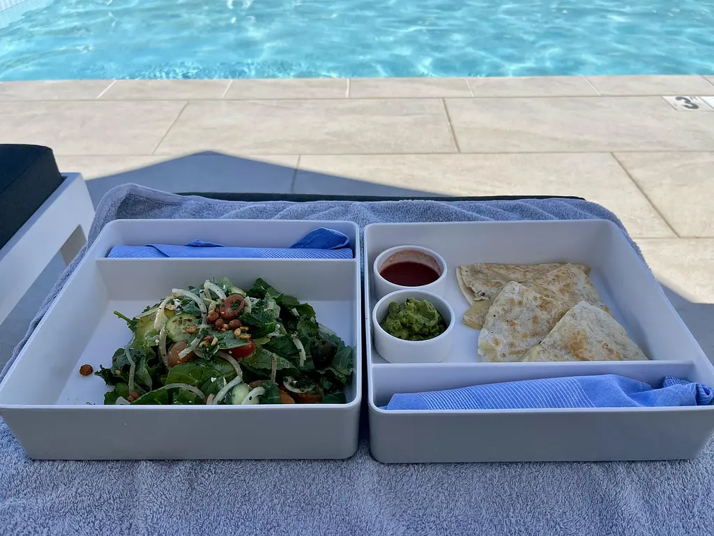 Poolside dining at Lola Rose - Salad and Quesadilla